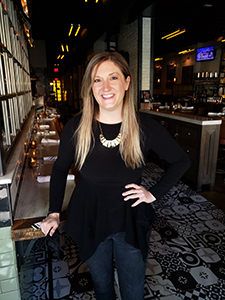 Woman smiling inside oyster bar area of restaurant