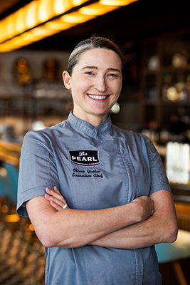 Executive Chef Olivia Giesler standing in the dining room at The Pearl at Water Street in Tampa, Florida.