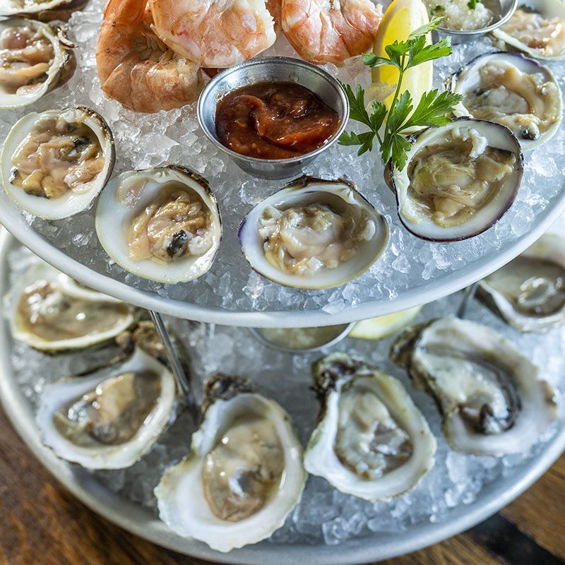 Oysters on the half shell, on round tower trays of ice at The Pearl restaurant at Water Street in Tampa, Florida