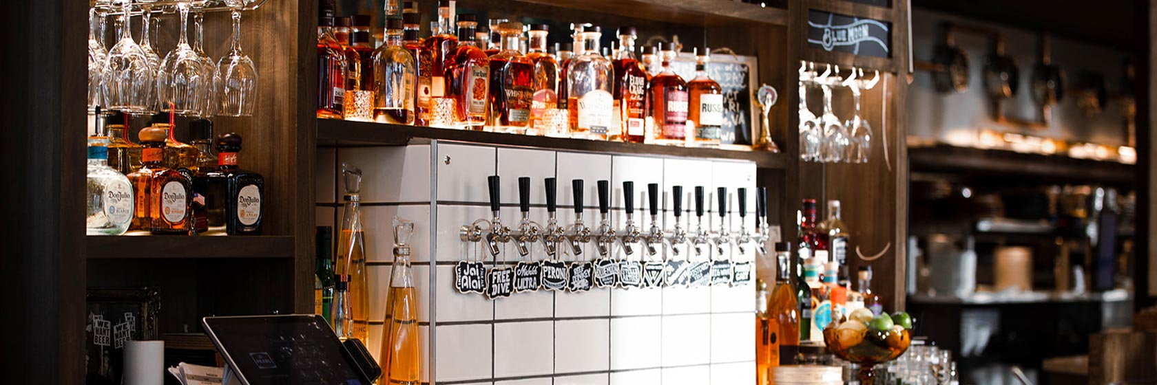 Series of beer taps under spirits in the bar at The Pearl at Water Street in Tampa, Florida.