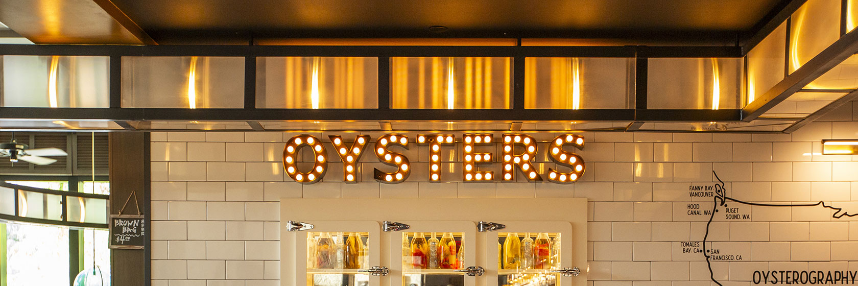 Lighted Oysters signage inside The Pearl restaurant at Water Street in Tampa, Florida.