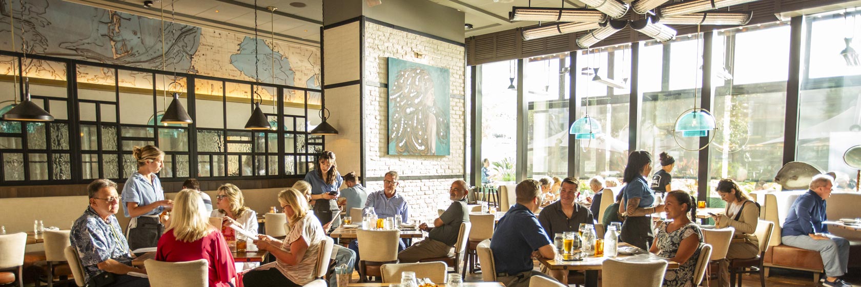 Daylight fills the dining room where guests enjoy lunch at The Pearl at Water Street in Tampa, Florida.