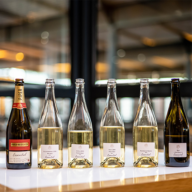 Row of Piper Hiedseick champagnes on bar top, served at The Pearl in Tampa, Florida.