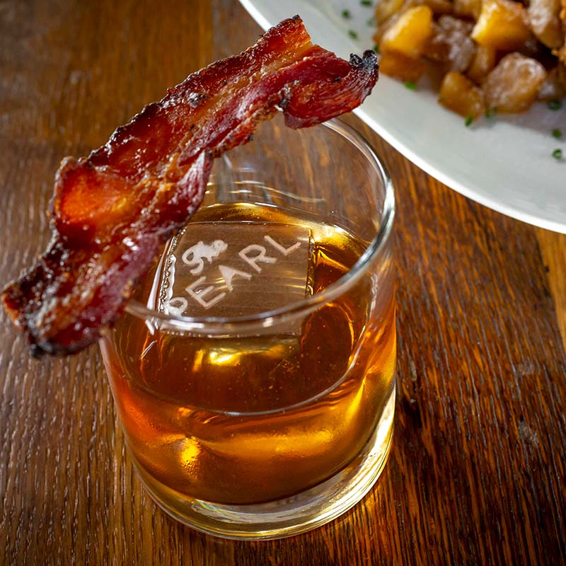 The Bourbon. Bacon. Boozy. cocktail served at The Pearl - a Cameron Mitchell Restaurant.